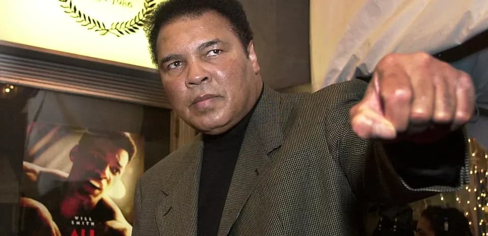 Muhammad Ali gesturing with a raised fist