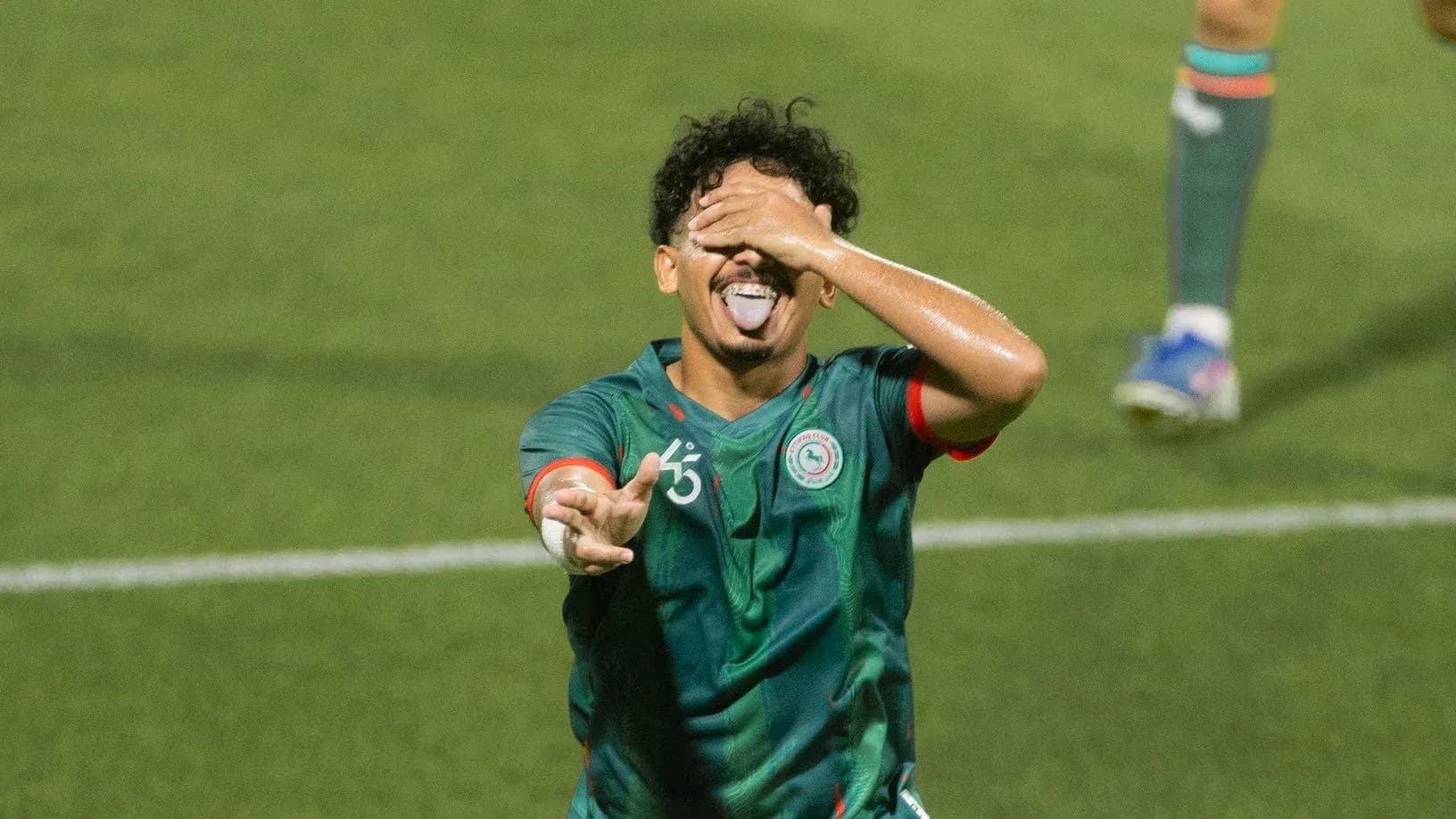 Joueur célébrant un but sur le terrain de football