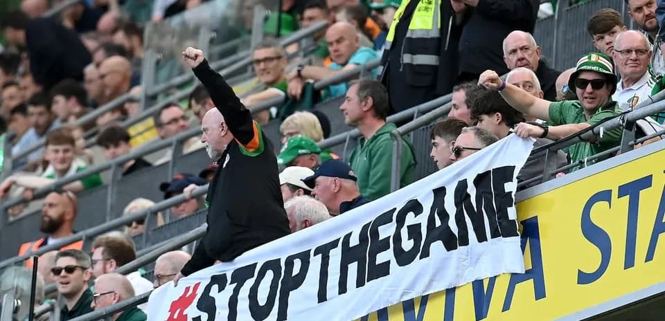 Supporters holding banner during a football match
