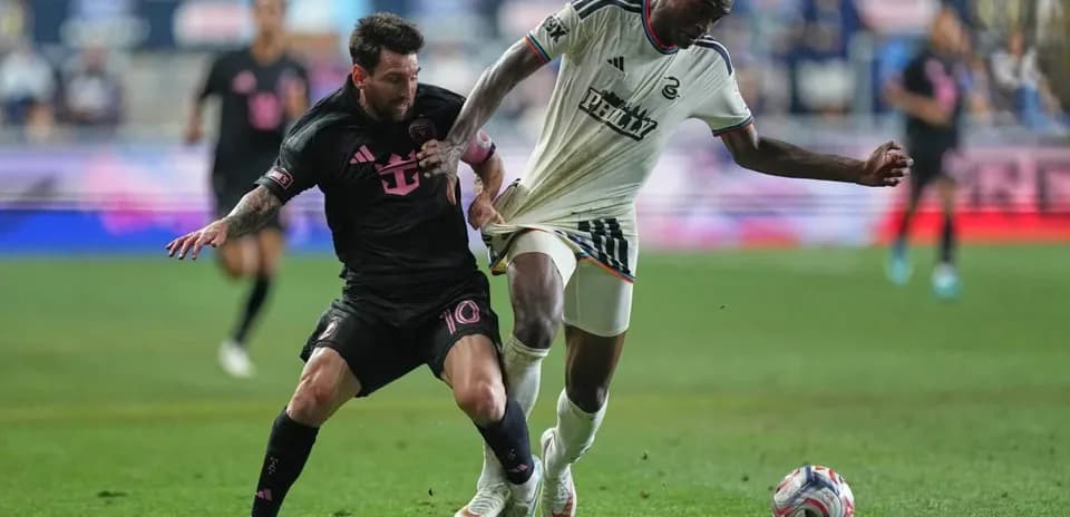 Lionel Messi tackling a Philadelphia player during match
