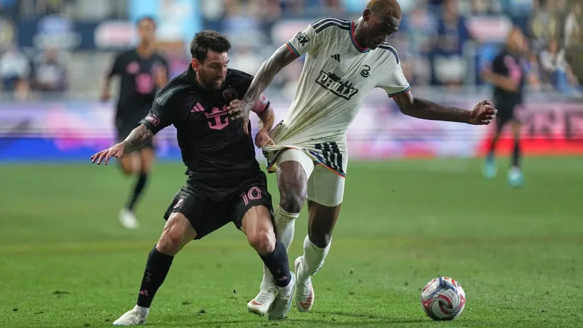 Lionel Messi tackling a Philadelphia player during match