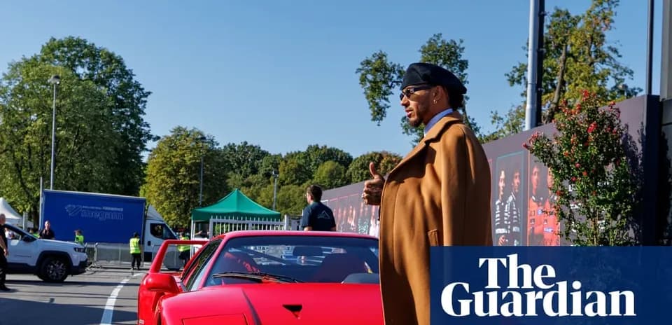 Homme en manteau près d'une voiture rouge