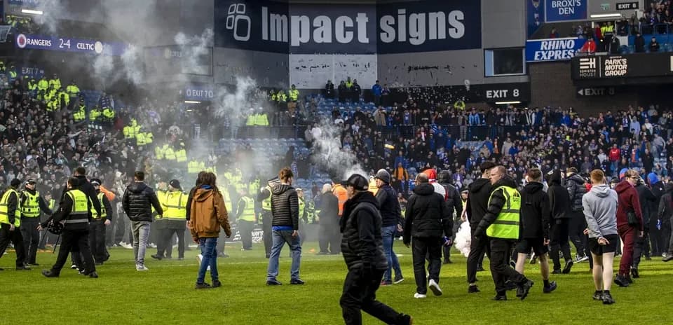 Supporters and security on the pitch after match