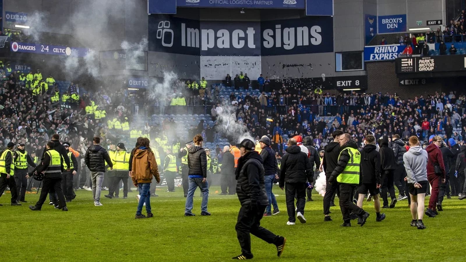 Supporters and security on the pitch after match