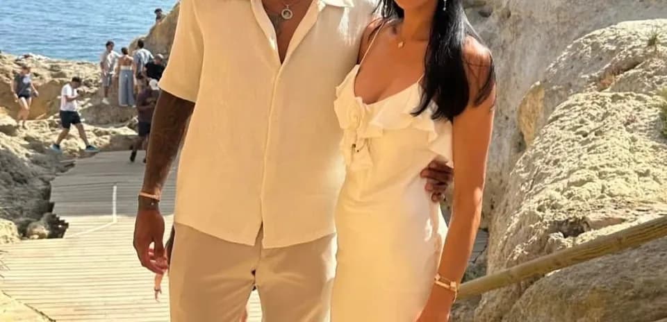 Couple posing on a rocky beach pathway