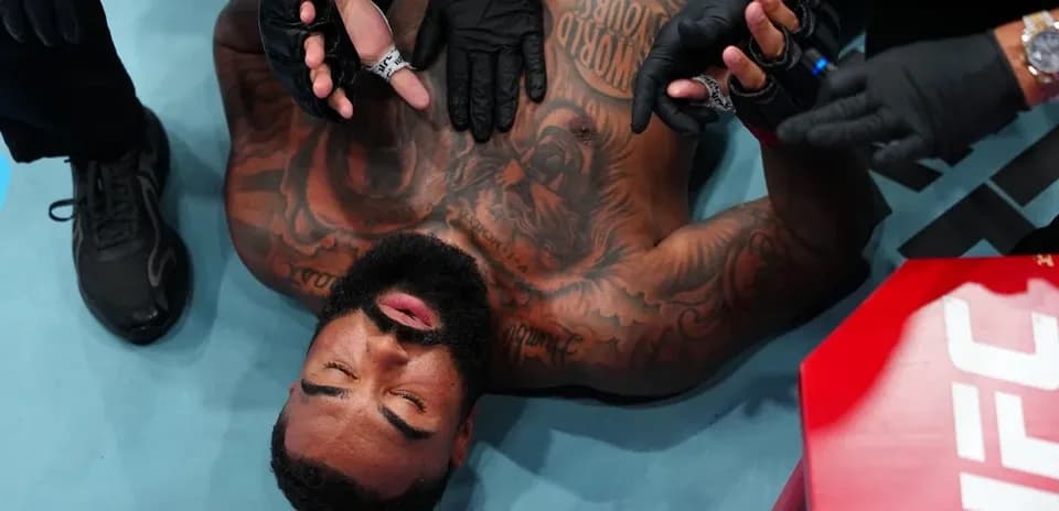 Fighter receiving medical attention in the octagon