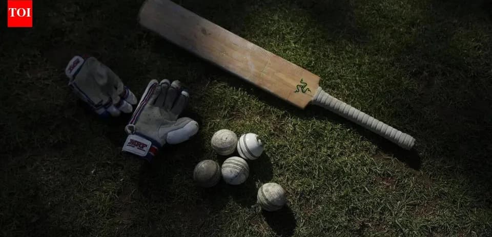 Batte, gants et balles de cricket sur l'herbe