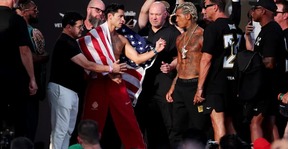 Boxers facing off at weigh-in with crowd present