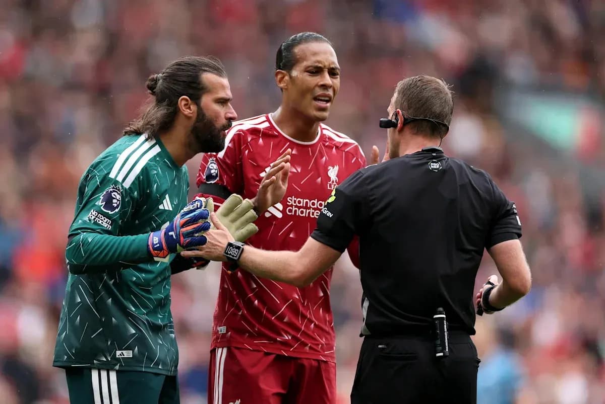 Joueurs de Liverpool discutant avec l'arbitre pendant un match
