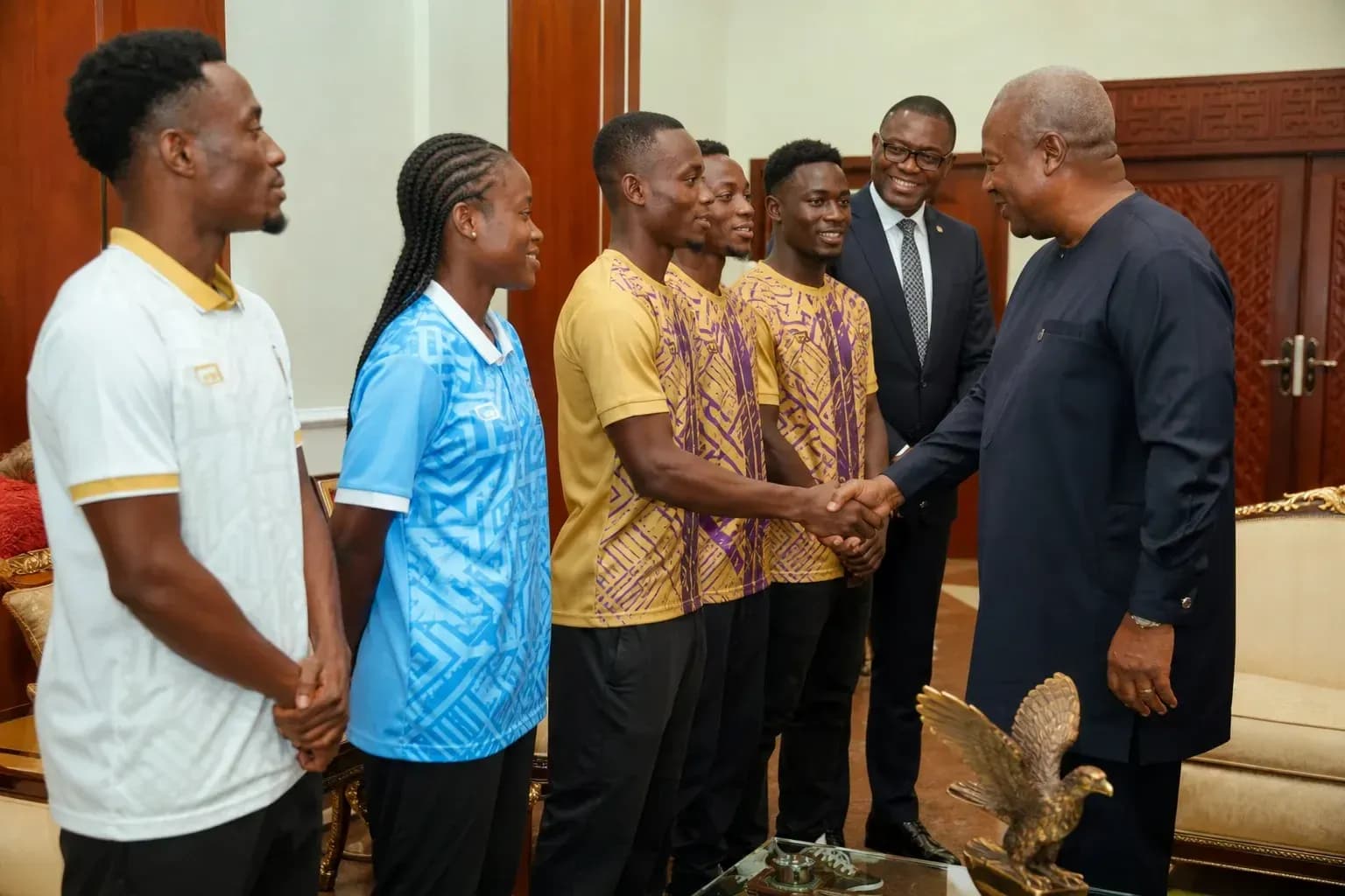 Athletes meeting with a dignitary in an office