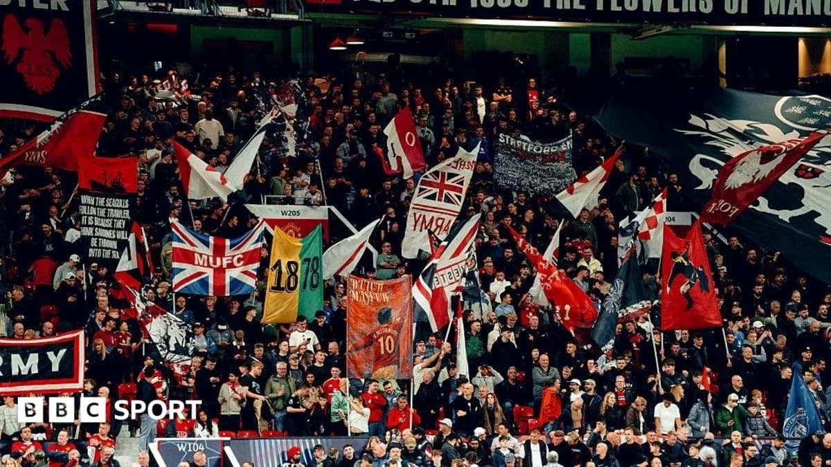 Supporters waving flags in a stadium crowd