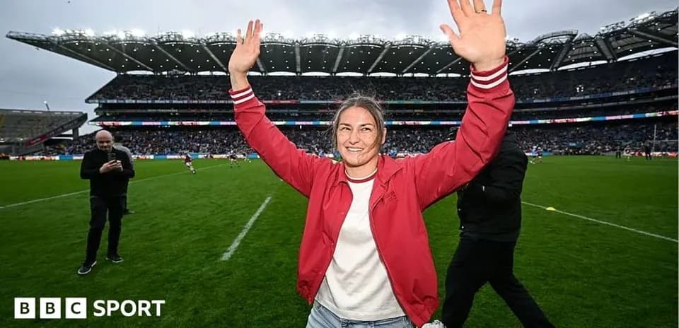 Femme levant les bras sur le terrain de rugby