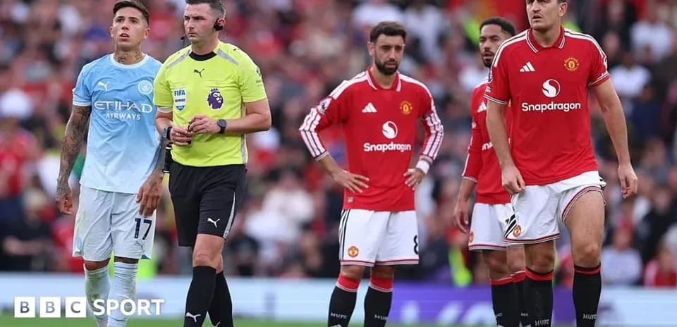 Joueurs de Manchester United et arbitre sur le terrain
