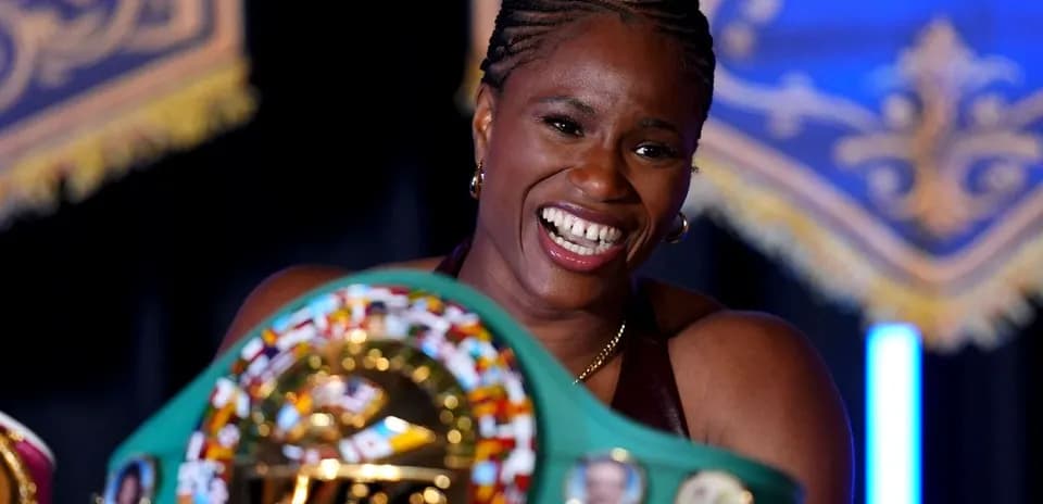 Boxeuse souriante tenant sa ceinture de championne