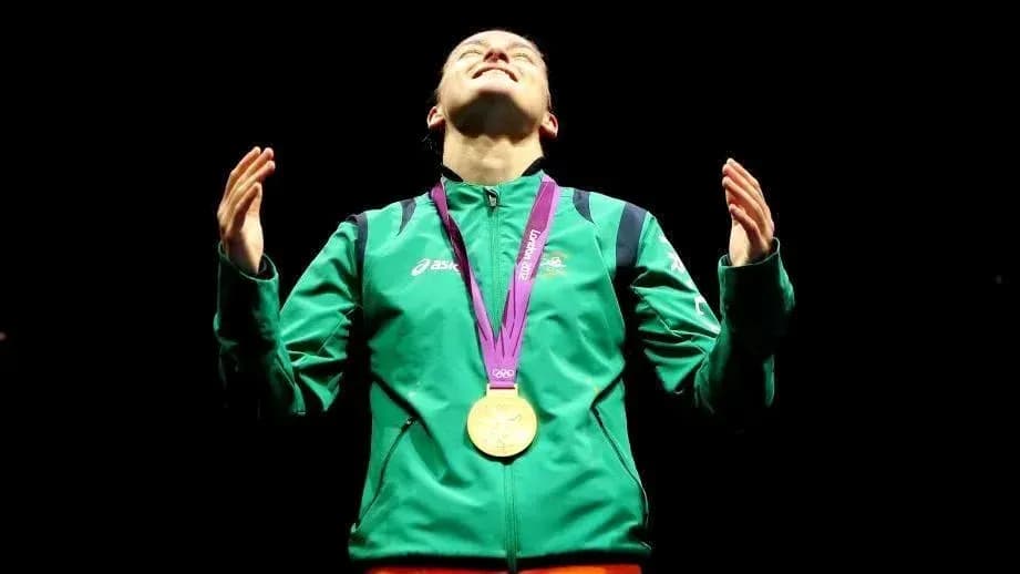 Athlete celebrating with gold medal at podium