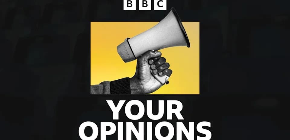 Mainly black and white image of a hand holding a megaphone