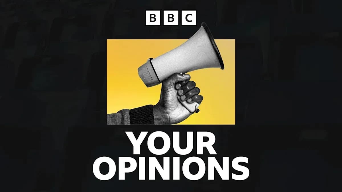 Mainly black and white image of a hand holding a megaphone