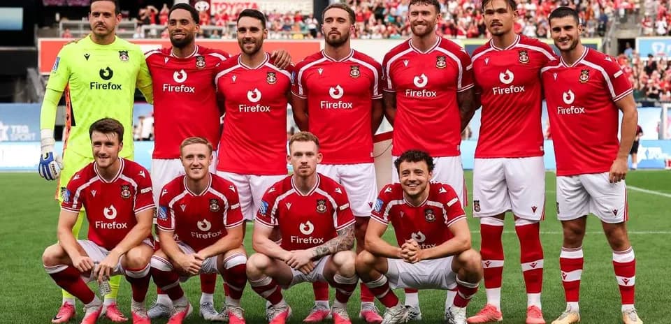 Équipe de football posant en maillots rouges