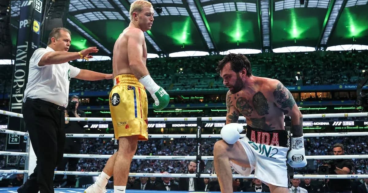 Boxer kneeling in ring with referee observing