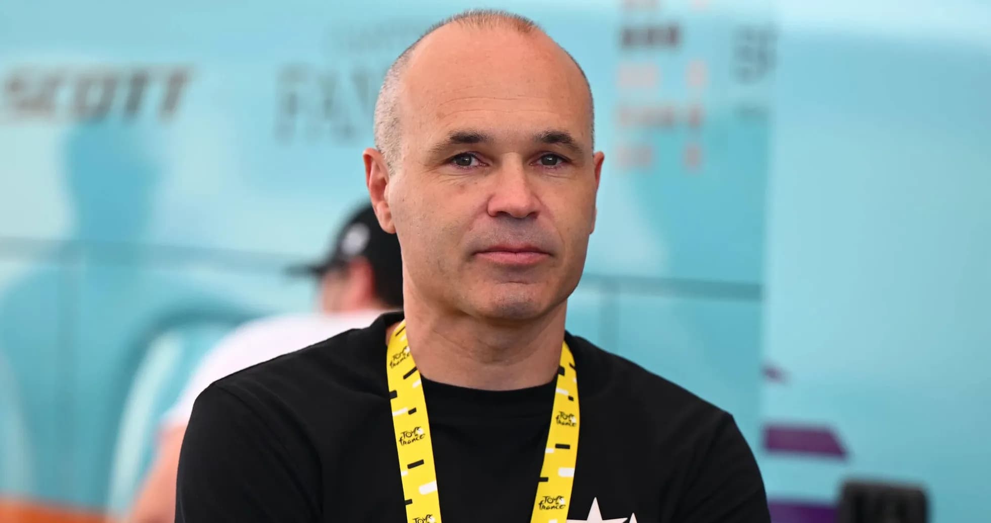 Homme avec un badge au cou dans un environnement sportif