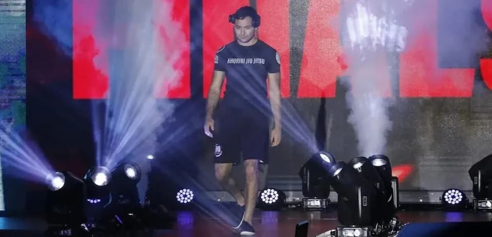 Athlete walking to the stage with spotlight and smoke