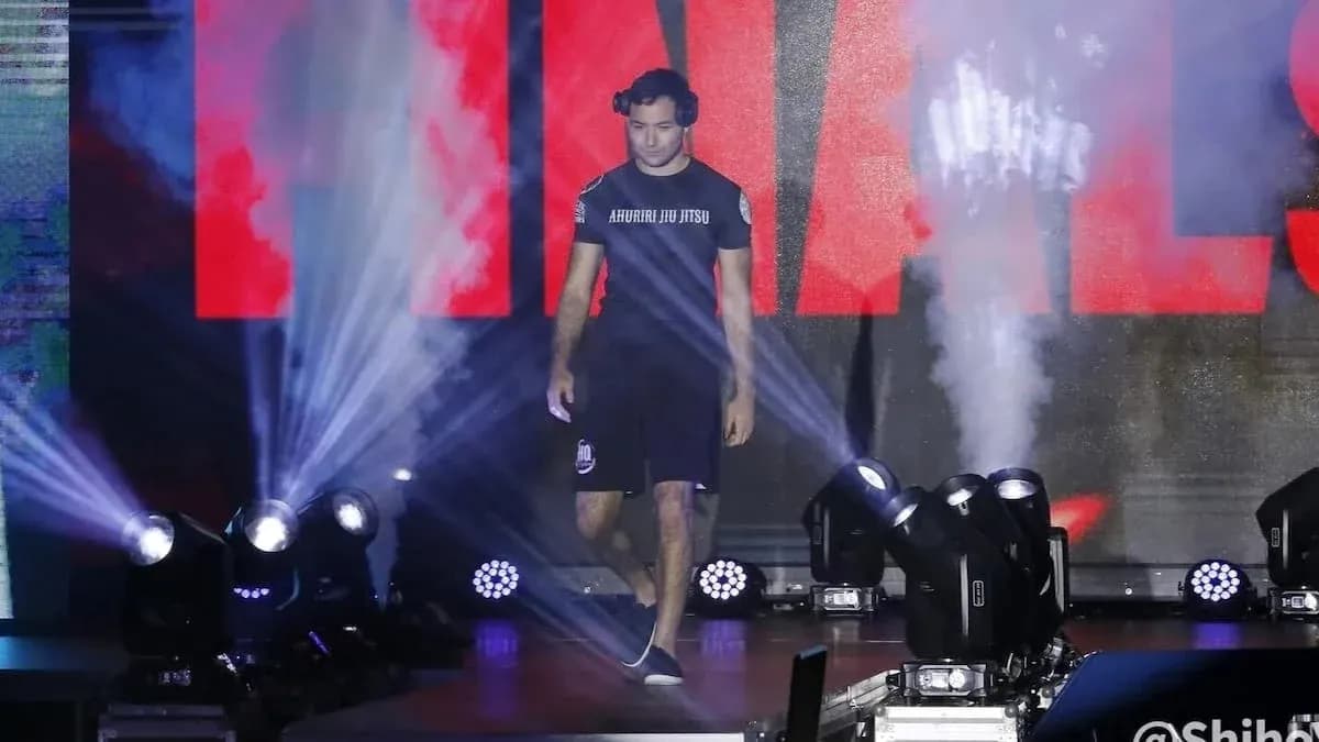Athlete walking to the stage with spotlight and smoke