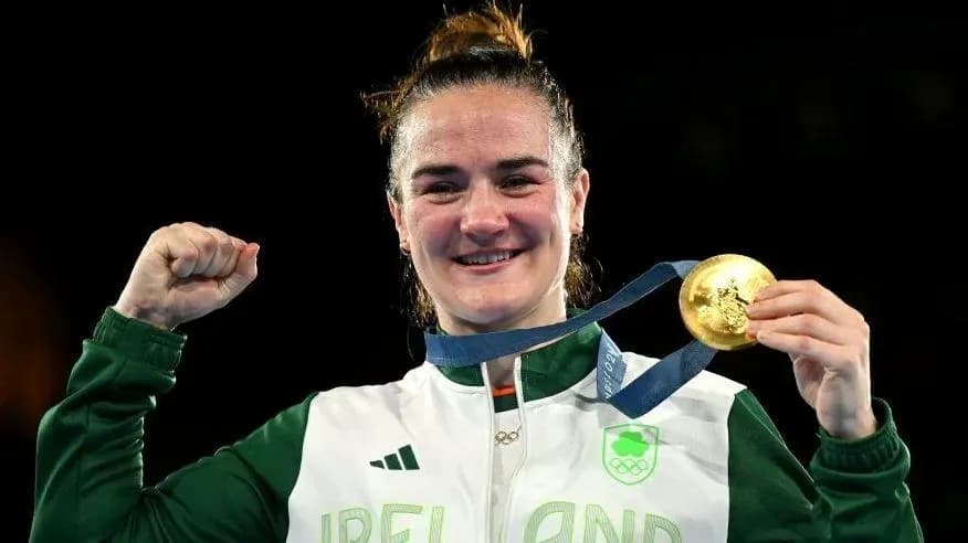Athlete celebrating with gold medal at event