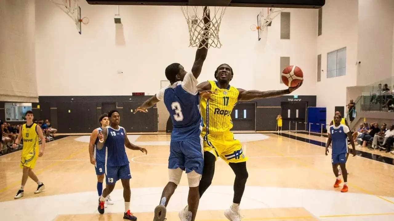 Joueur dunkant au panier pendant un match de basket