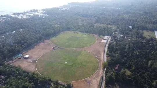 Aerial view of two cricket fields surrounded by trees