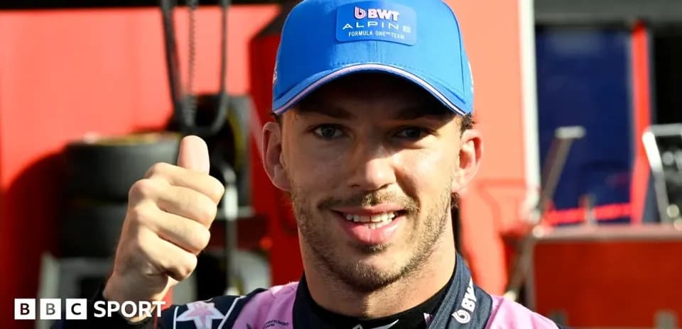 Pilote montrant un pouce levé dans le paddock