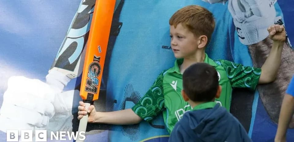 Enfant avec une batte de cricket posant fièrement