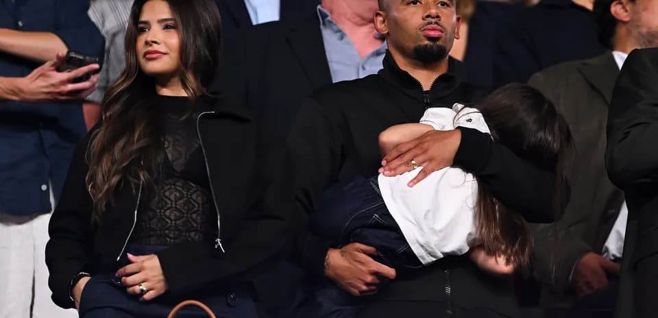 Couple with child watching an event in the stands