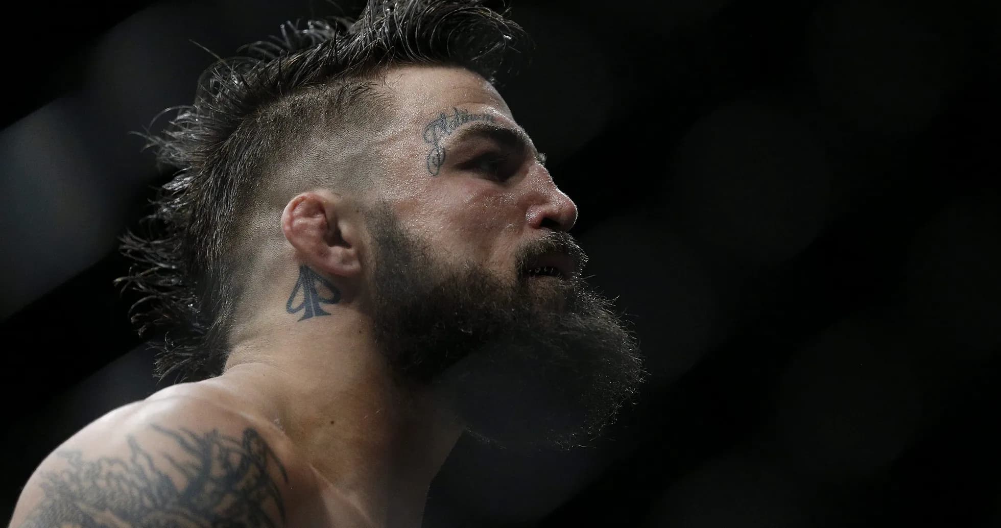 Fighter with tattoos preparing for match