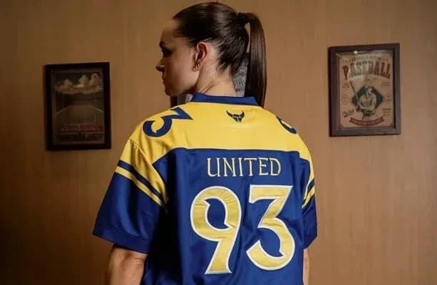 Person wearing a blue and yellow jersey with '93' and 'UNITED'