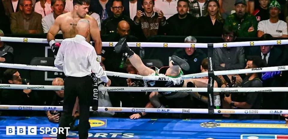 Boxer falling out of the ring after a knockout