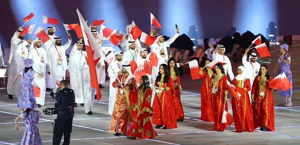 Participants waving Bahrain flags during opening ceremony