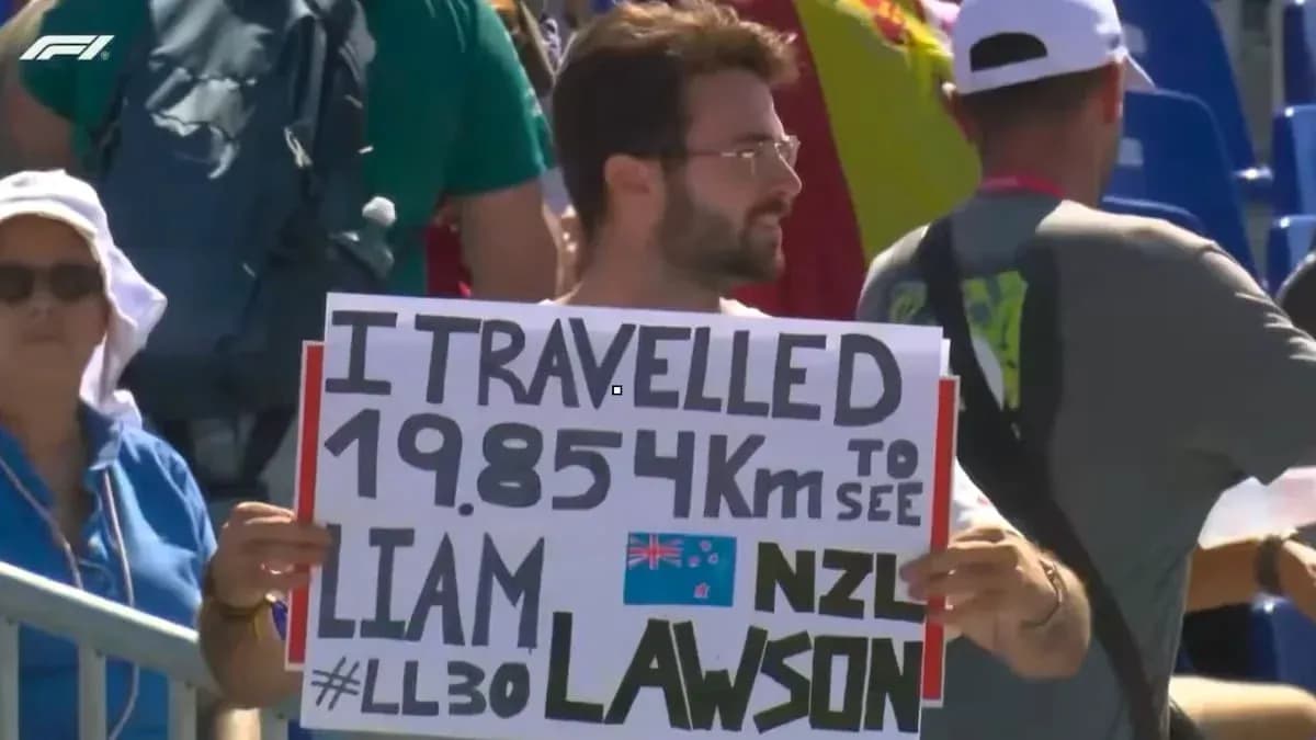 Spectator holding sign for Liam Lawson at event