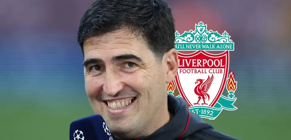 Interviewer smiling with Liverpool FC logo in background