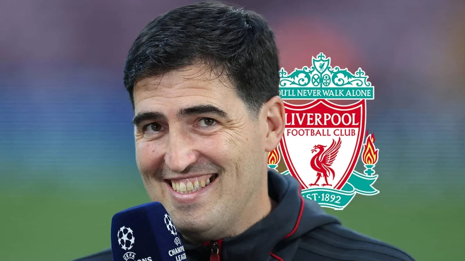 Interviewer smiling with Liverpool FC logo in background