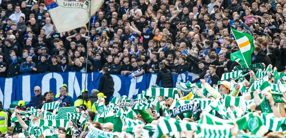 Supporters waving scarves during a football match