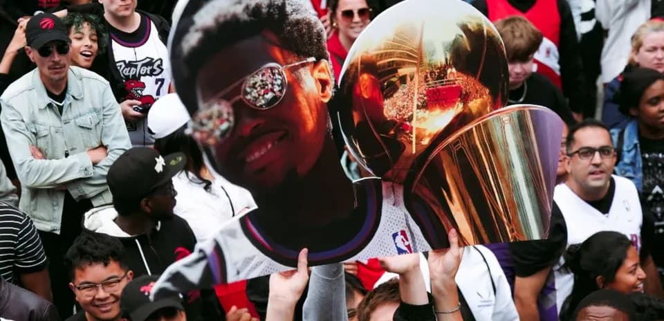 Fans celebrating with a large trophy cutout