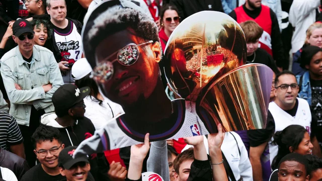 Fans celebrating with a large trophy cutout