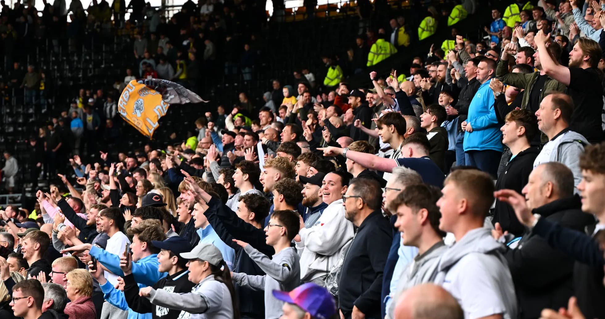 Supporters cheering enthusiastically in the stadium