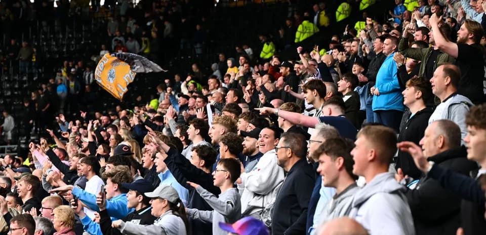 Supporters cheering enthusiastically in the stadium