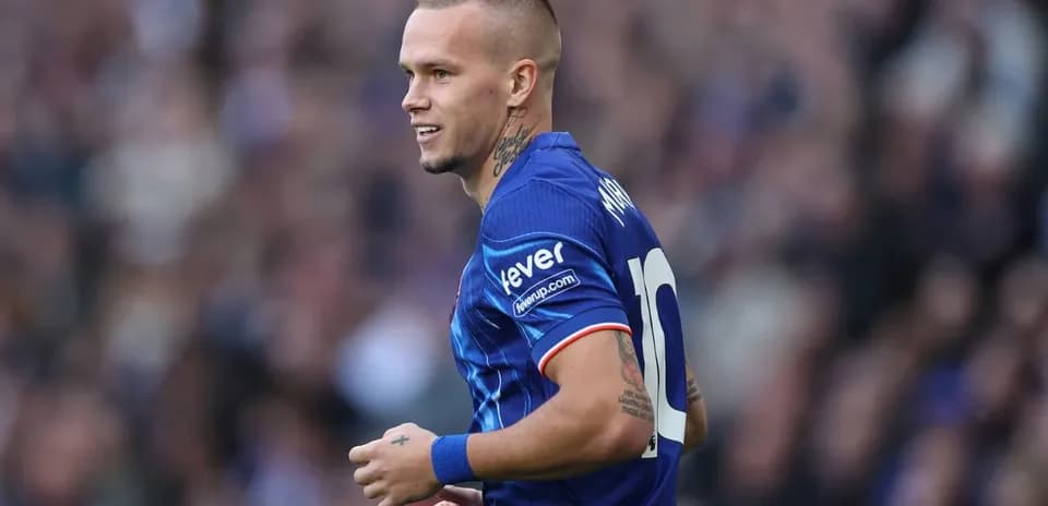 Joueur en maillot bleu marchant sur le terrain