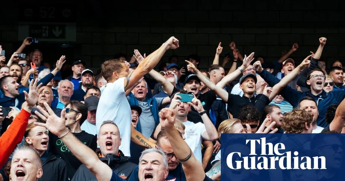 Supporters cheering passionately in the stands