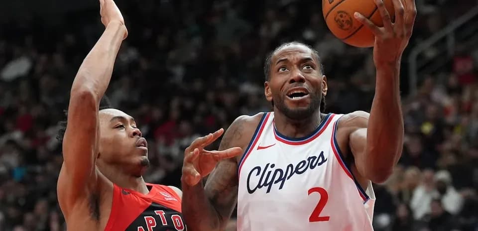 Kawhi Leonard shooting while defended by opponent