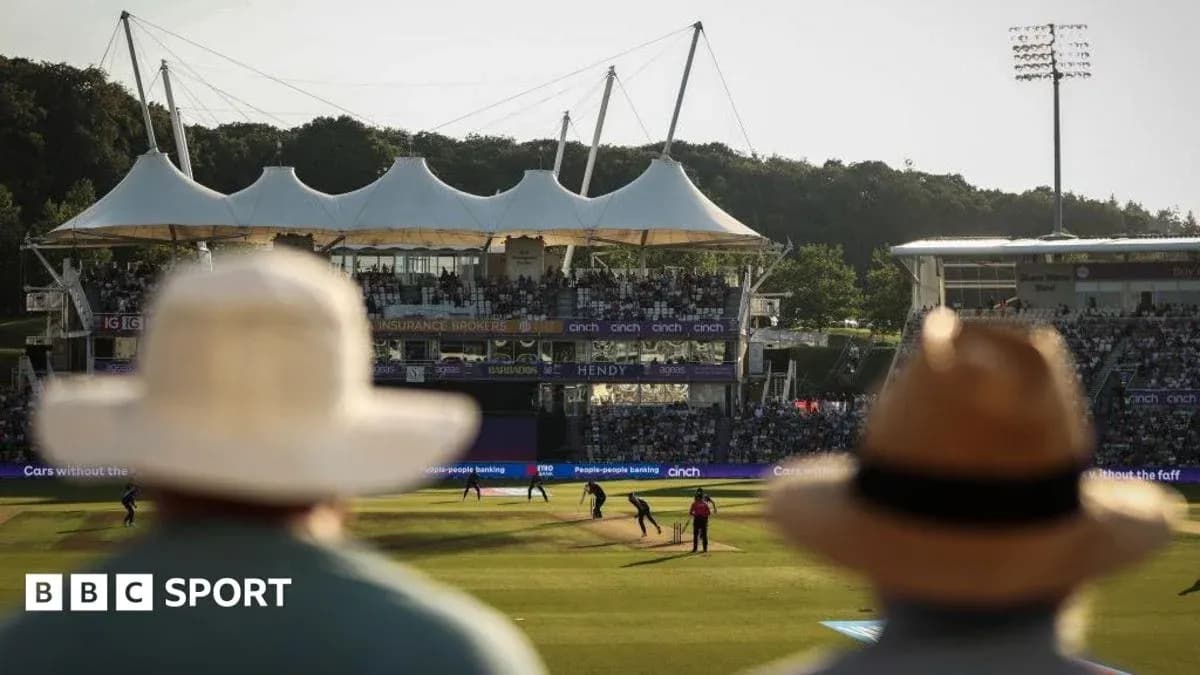 Spectators watching a cricket match at stadium