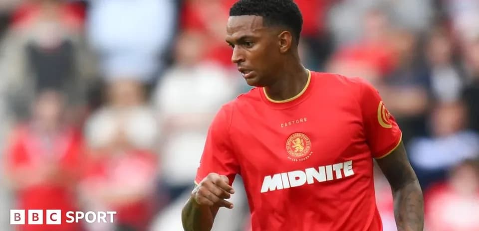 Joueur en action sur le terrain avec maillot rouge