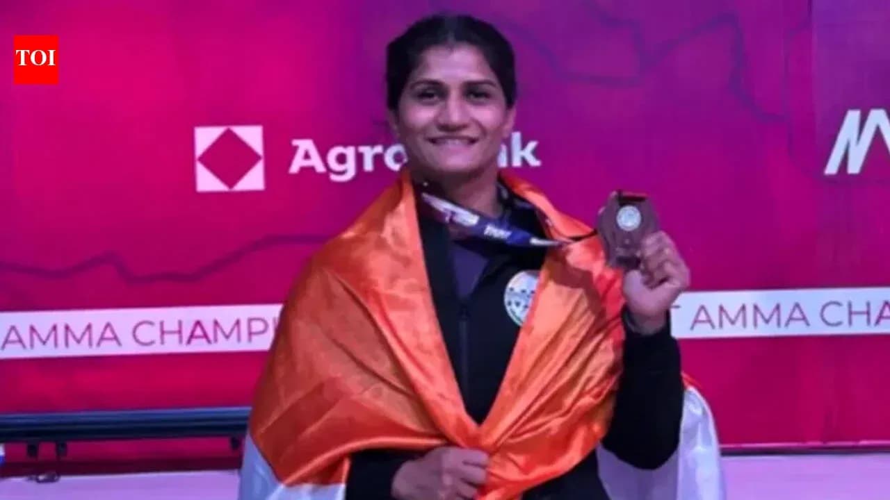 Athlete celebrating with medal and flag at podium